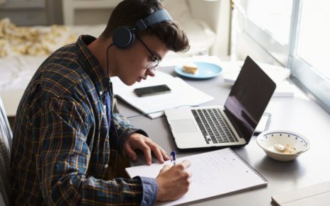 A Teenage Boy Hearing Music While Preparing For Competitive Exams.
