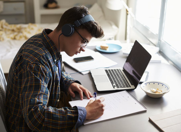 A Teenage Boy Hearing Music While Preparing For Competitive Exams.